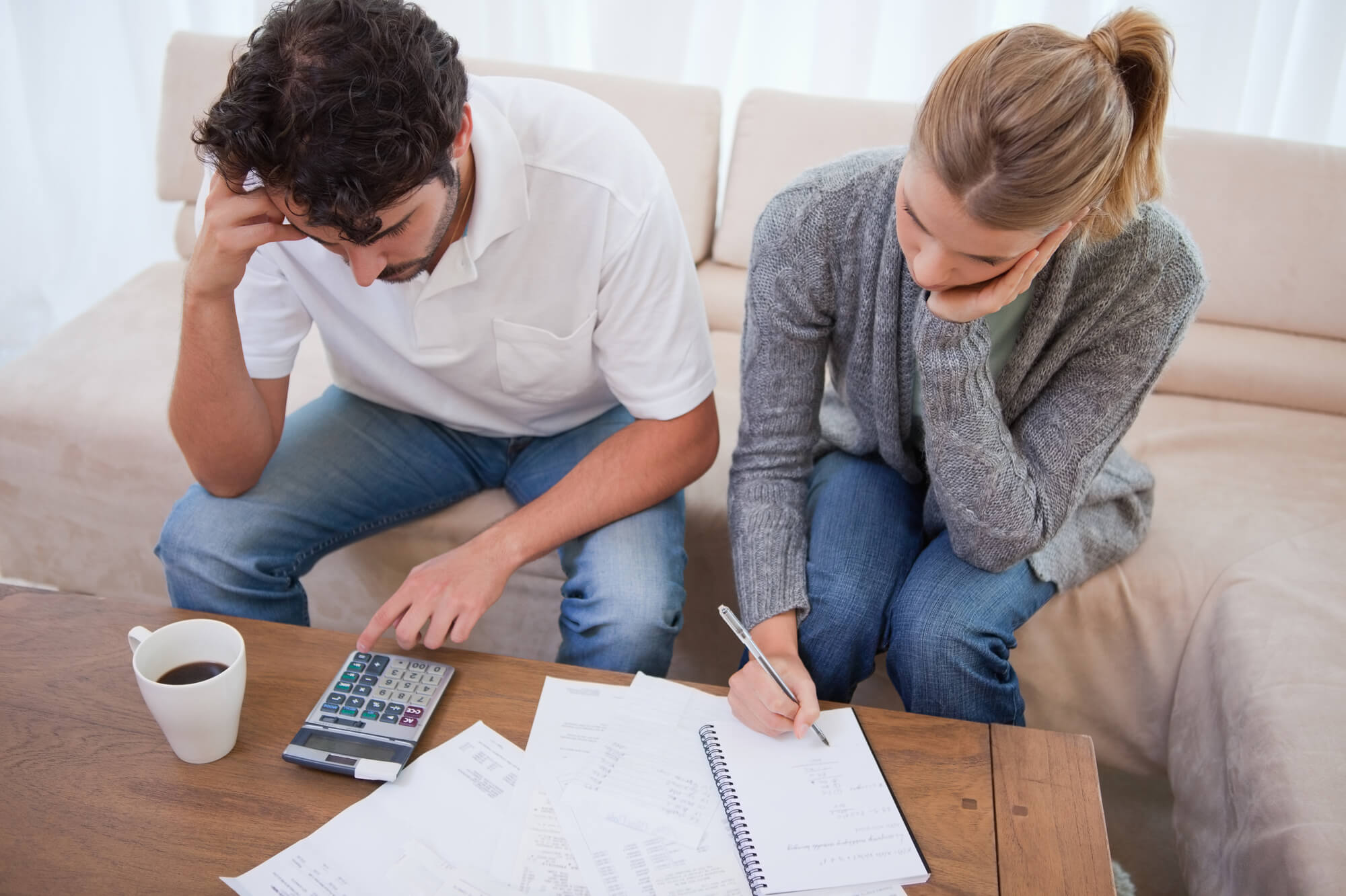 Couple looking at their bills in their living room